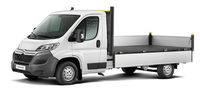 White flatbed truck viewed from the side.