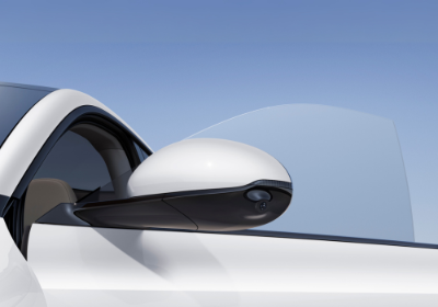 Close-up of white car's side mirror and partially open window.