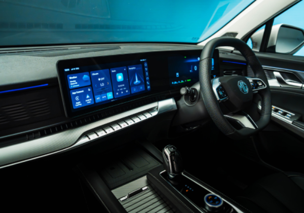 Interior of a car showcasing a digital dashboard and steering wheel.